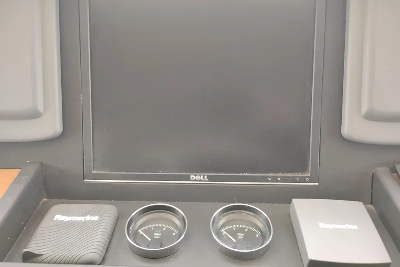 Slide: The Image of Control panel of a 1977 Custom International Offshore 65 with Raymarine equipment. - 43