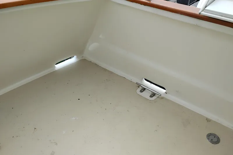Slide: The Image of Interior view of a 1977 Custom International Offshore 65 boat deck, featuring clean white surfaces. - 5