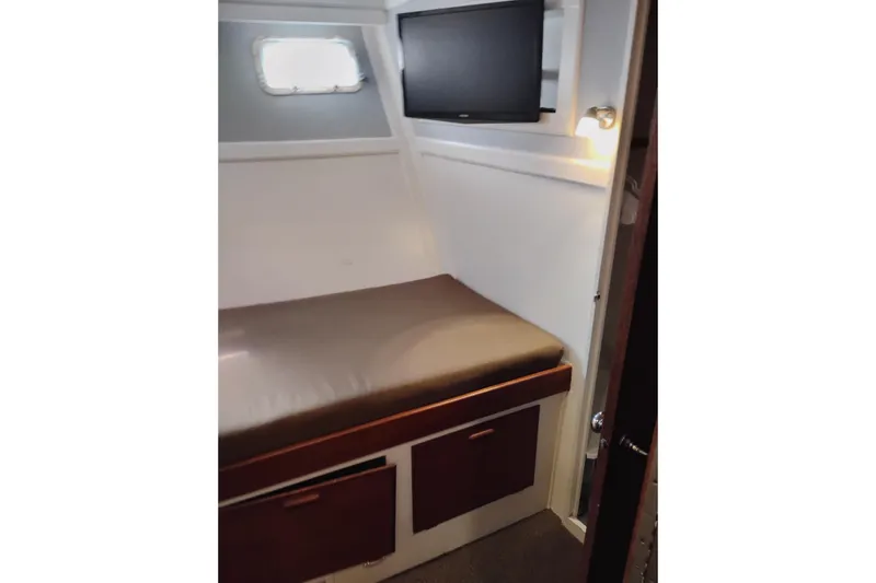 Slide: The Image of Cozy cabin interior of 1977 Custom International Offshore 65 yacht with bed and TV. - 50