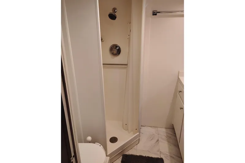 Slide: The Image of Compact shower area in a 1977 Custom International Offshore 65 yacht bathroom. - 52