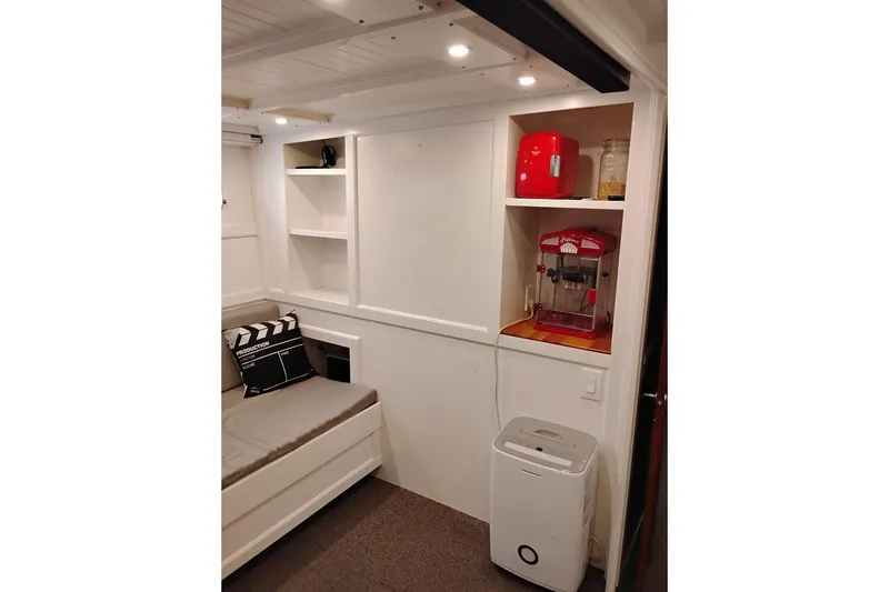 Slide: The Image of Cozy interior of 1977 Custom International Offshore 65 with popcorn maker and seating area. - 55