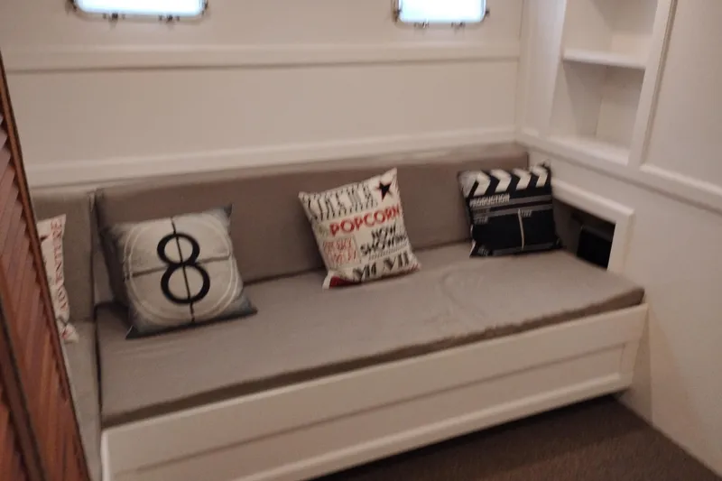 Slide: The Image of Cozy cabin interior of 1977 Custom International Offshore 65 with decorative pillows. - 56
