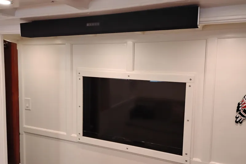 Slide: The Image of Interior of 1977 Custom International Offshore 65 yacht with mounted TV and soundbar. - 58