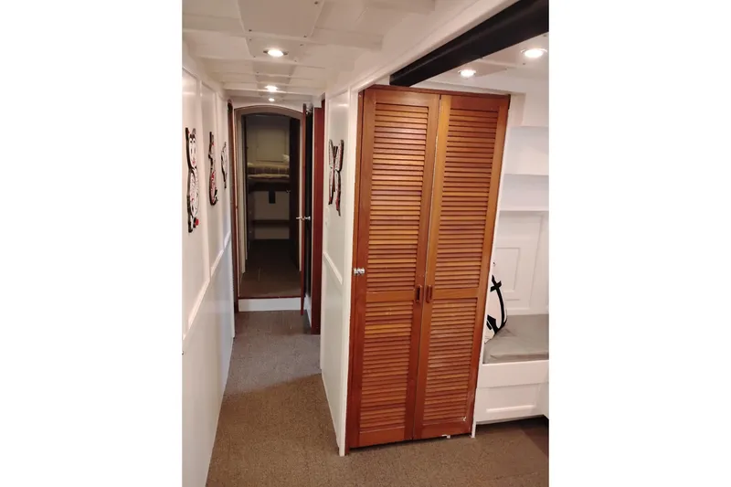 Slide: The Image of Interior hallway of 1977 Custom International Offshore 65 yacht with wooden closet doors. - 59