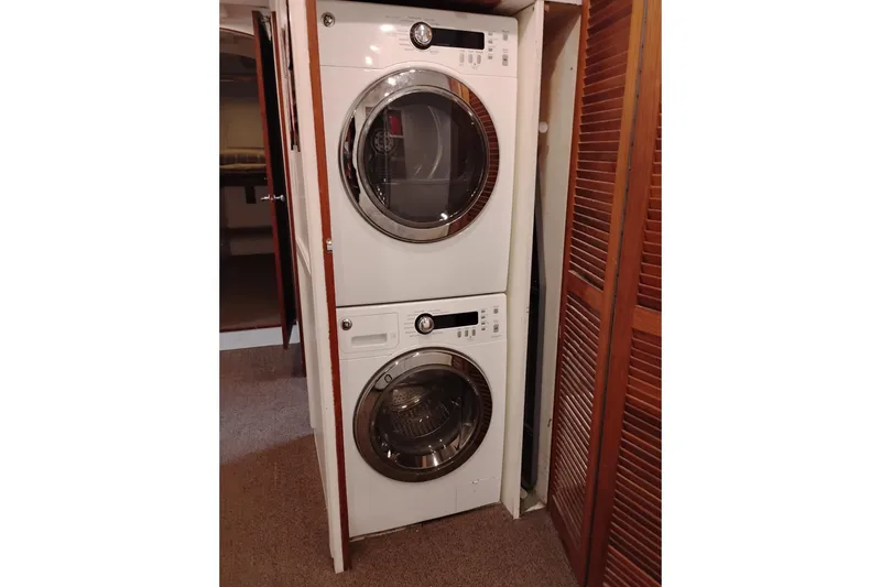 Slide: The Image of Stacked washer and dryer inside a 1977 Custom International Offshore 65 yacht. - 60