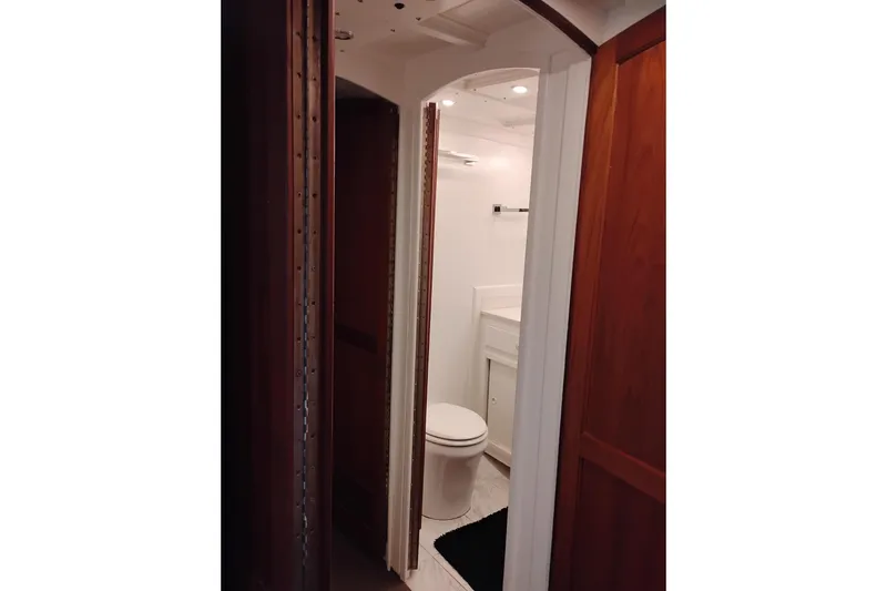 Slide: The Image of Interior view of a 1977 Custom International Offshore 65 yacht bathroom with wooden accents. - 62