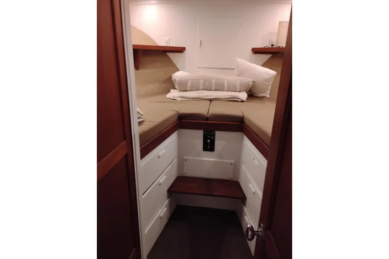 Slide: The Image of Cozy cabin interior of 1977 Custom International Offshore 65 yacht with bed and storage. - 67