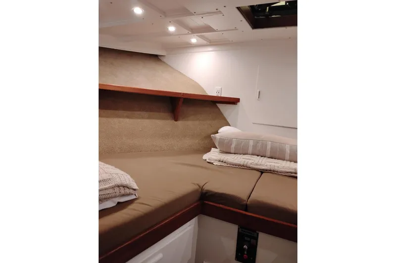Slide: The Image of Cozy cabin interior of 1977 Custom International Offshore 65 yacht with comfortable bedding. - 69