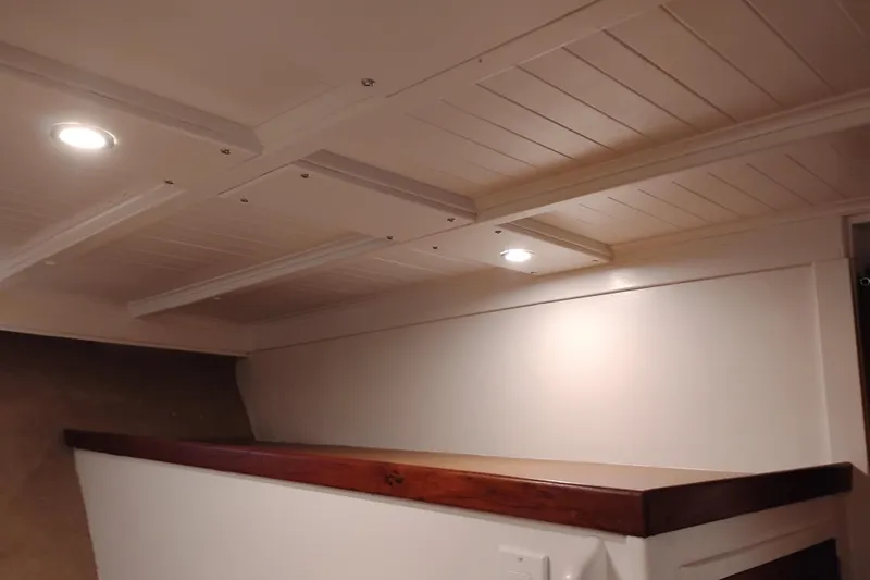 Slide: The Image of Interior of 1977 Custom International Offshore 65 yacht with wooden trim and recessed lighting. - 70