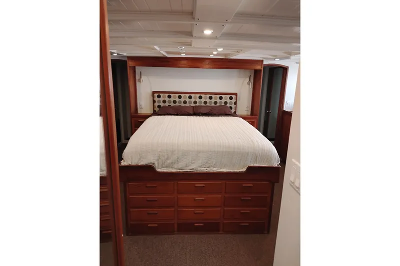 Slide: The Image of Luxurious bedroom interior of 1977 Custom International Offshore 65 yacht with wooden cabinetry. - 72