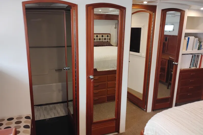 Slide: The Image of Interior of 1977 Custom International Offshore 65 yacht with wooden doors and cozy bedroom. - 77