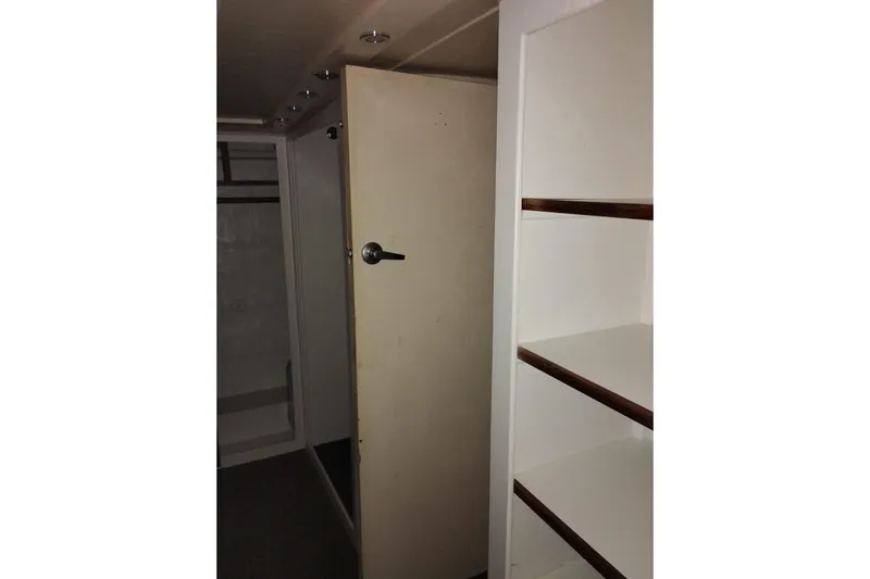 Slide: The Image of Interior of 1977 Custom International Offshore 65 yacht with open door and shelving. - 90