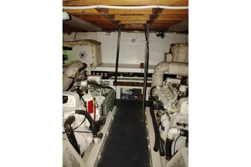 Slide: The Image of Engine room of a 1977 Custom International Offshore 65 yacht, showcasing machinery and equipment. - 91