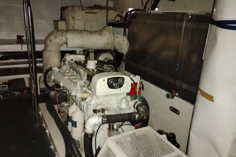 Slide: The Image of Engine room of a 1977 Custom International Offshore 65 yacht, showcasing machinery and components. - 92