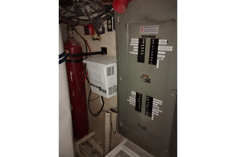 Slide: The Image of Electrical panel and equipment inside a 1977 Custom International Offshore 65 boat. - 93