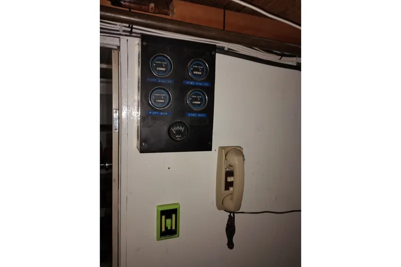 Slide: The Image of Control panel and vintage phone on 1977 Custom International Offshore 65 yacht. - 94