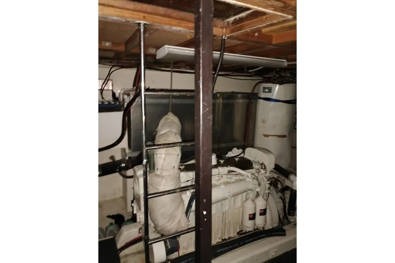 Slide: The Image of Engine room of a 1977 Custom International Offshore 65 yacht, showcasing machinery and equipment. - 95
