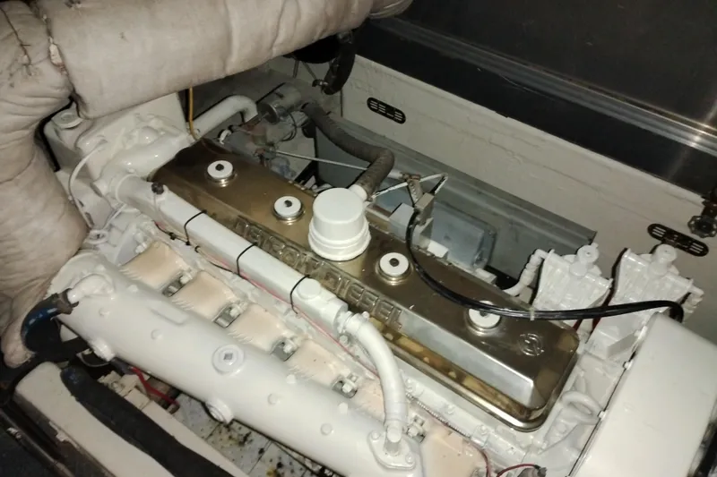 Slide: The Image of Engine of a 1977 Custom International Offshore 65 boat, showcasing detailed components. - 96