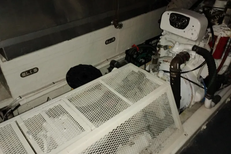 Slide: The Image of Engine compartment of a 1977 Custom International Offshore 65 boat, featuring mechanical components. - 97