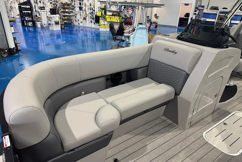 Slide: The Image of 2026 Bentley Pontoons Elite 223 Admiral interior with luxurious seating in showroom. - 15