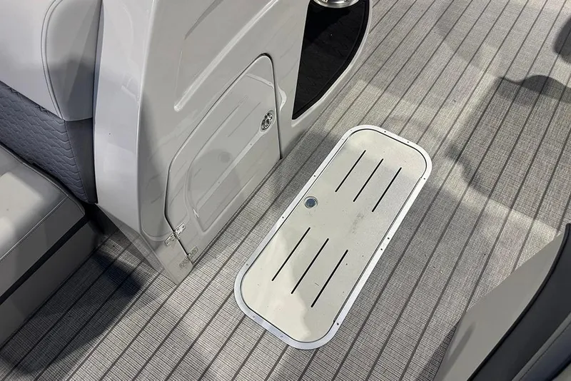 Slide: The Image of 2026 Bentley Pontoons Elite 223 Admiral interior with sleek flooring and storage compartment. - 17