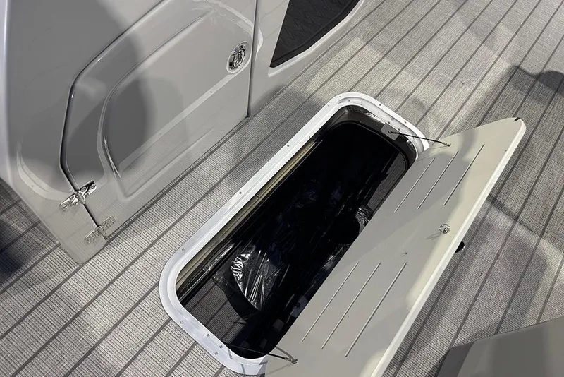Slide: The Image of 2026 Bentley Pontoons Elite 223 Admiral storage compartment on deck, open hatch view. - 18