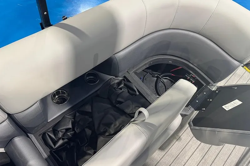 Slide: The Image of 2026 Bentley Pontoons Elite 223 Admiral interior seating with storage and cup holders. - 29