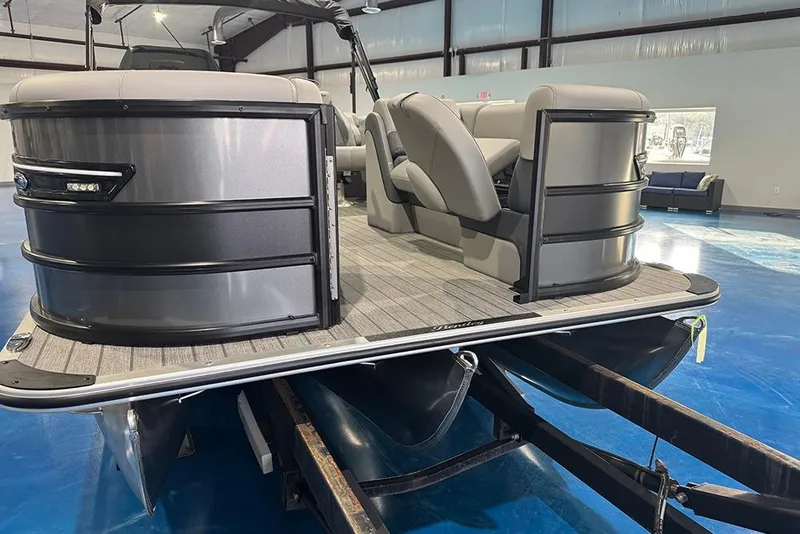 Slide: The Image of 2026 Bentley Pontoons Elite 223 Admiral pontoon boat in showroom, showcasing sleek design and seating. - 3