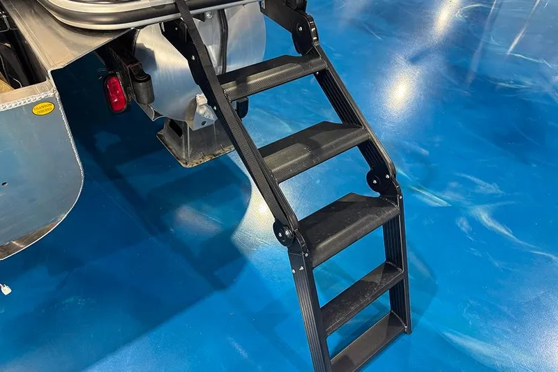 Slide: The Image of 2026 Bentley Pontoons Elite 223 Admiral with black boarding ladder on blue floor. - 9