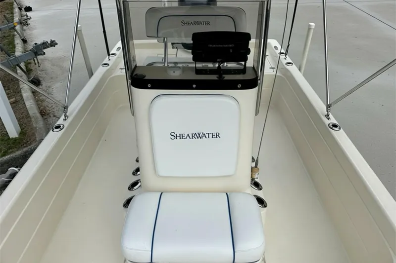 Slide: The Image of 2006 ShearWater 2400Z boat interior with console and seating. - 13
