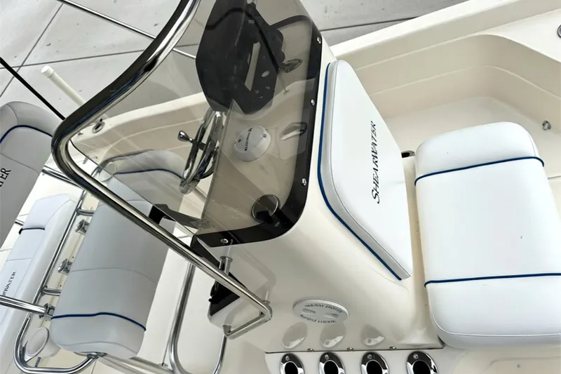Slide: The Image of 2006 ShearWater 2400Z boat interior with steering console and cushioned seating. - 15