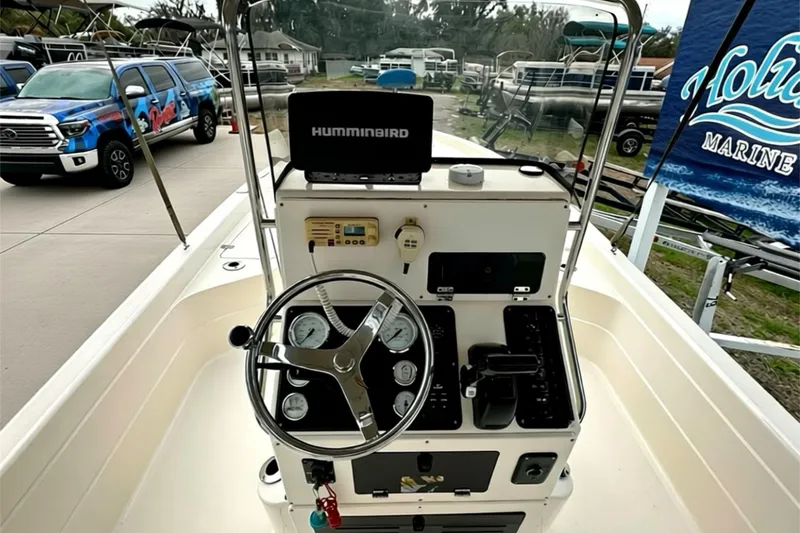 Slide: The Image of 2006 ShearWater 2400Z boat console with steering wheel and Humminbird navigation system. - 18
