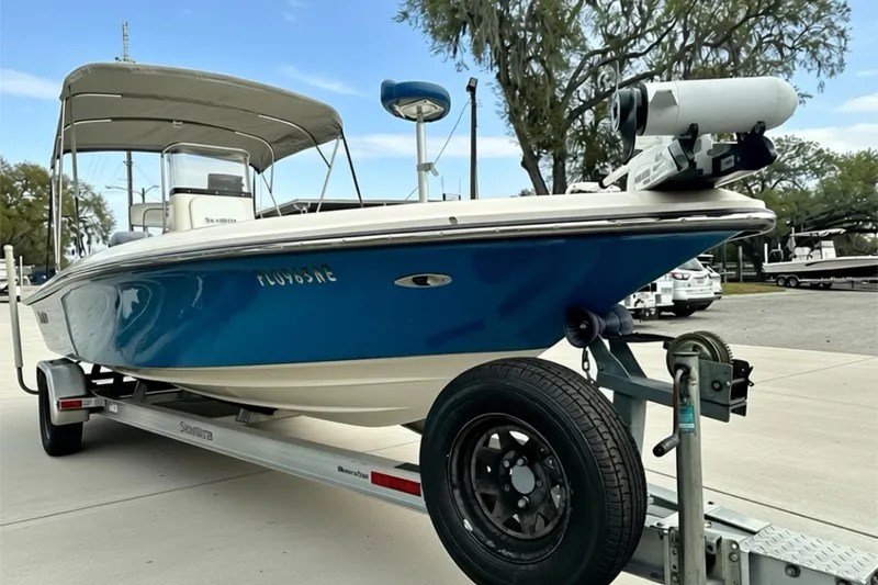 Slide: The Image of 2006 ShearWater 2400Z boat on trailer, blue hull, parked outdoors. - 2