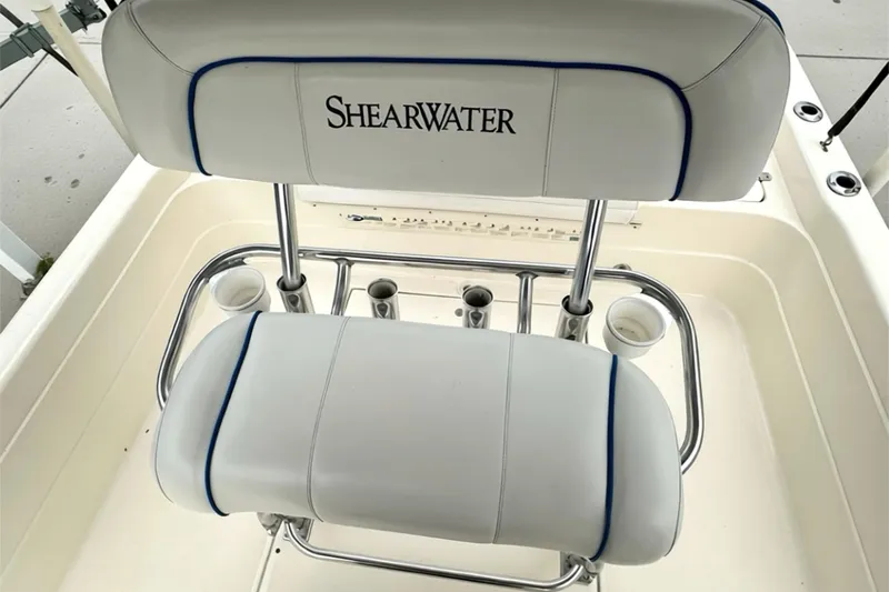 Slide: The Image of ShearWater 2400Z 2006 boat seating with cup holders and chrome accents. - 21