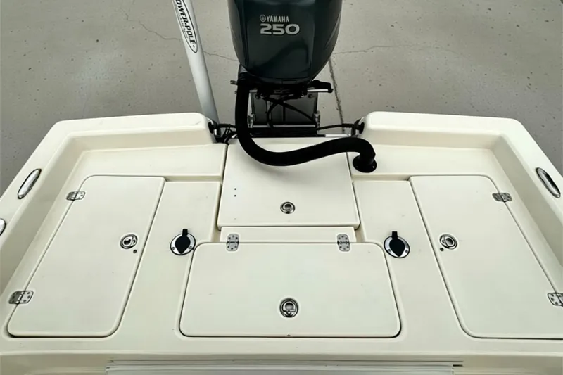 Slide: The Image of 2006 ShearWater 2400Z boat deck with Yamaha 250 engine, featuring storage compartments. - 24