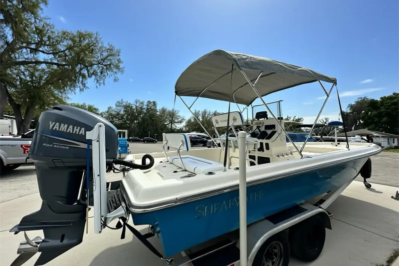 Slide: The Image of 2006 ShearWater 2400Z boat with Yamaha engine, parked on trailer under clear sky. - 27