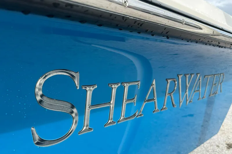 Slide: The Image of 2006 ShearWater 2400Z boat with blue hull and metallic logo. - 3