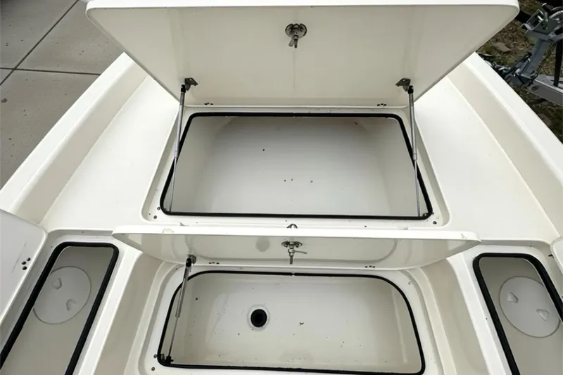 Slide: The Image of 2006 ShearWater 2400Z boat storage compartments open, showcasing spacious interior. - 6