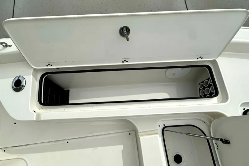 Slide: The Image of Open storage compartment on a 2006 ShearWater 2400Z boat, showcasing interior space. - 7