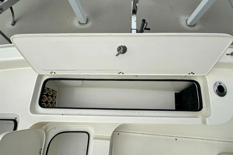 Slide: The Image of Open storage compartment on 2006 ShearWater 2400Z boat, showcasing interior space. - 8