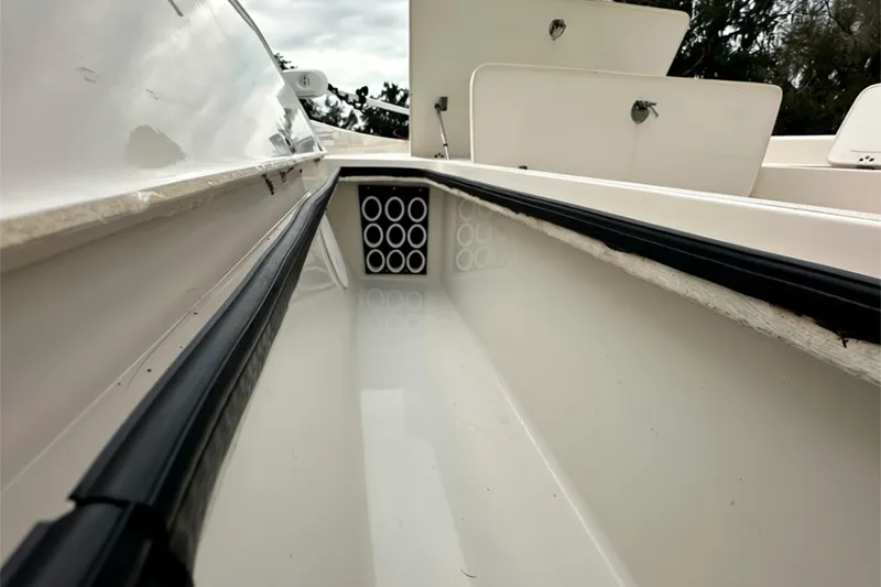 Slide: The Image of 2006 ShearWater 2400Z boat interior with storage compartments and rod holders. - 9