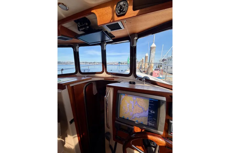 Slide: The Image of Interior view of 2012 Ranger Tugs R-29 boat with navigation system and scenic harbor. - 15