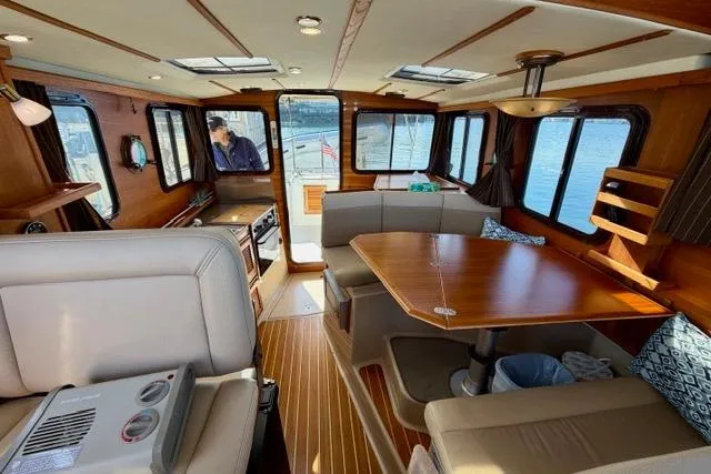 Slide: The Image of Interior of 2012 Ranger Tugs R-29 boat with wood accents and dining area. - 29