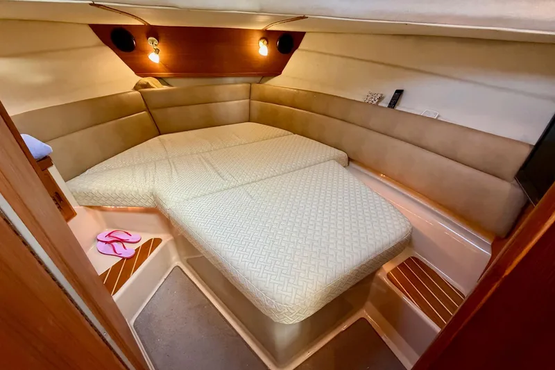 Slide: The Image of 2012 Ranger Tugs R-29 cabin interior with cozy bed and ambient lighting. - 32