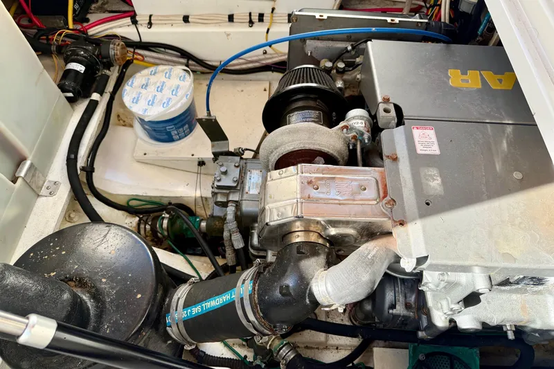 Slide: The Image of Engine compartment of a 2012 Ranger Tugs R-29 boat, showcasing mechanical components. - 43