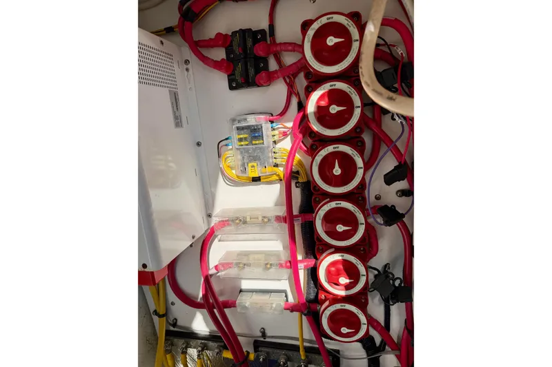 Slide: The Image of Electrical panel of a 2012 Ranger Tugs R-29 boat with red wiring and switches. - 47