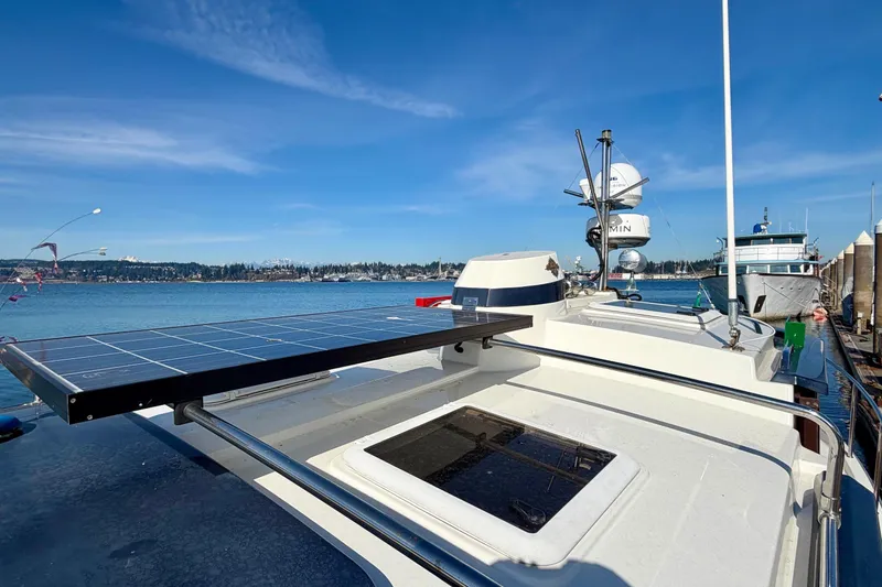 Slide: The Image of 2012 Ranger Tugs R-29 with solar panel, docked by the water on a sunny day. - 50