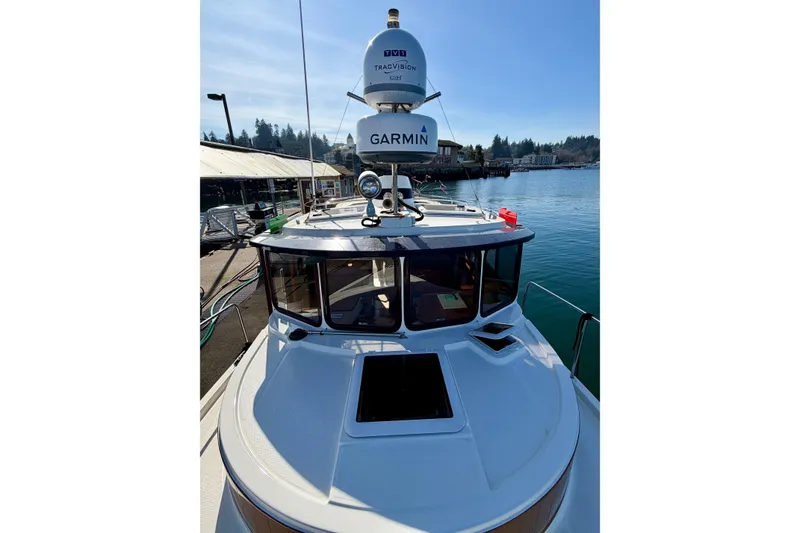 Slide: The Image of 2012 Ranger Tugs R-29 boat docked, featuring Garmin navigation equipment. - 52