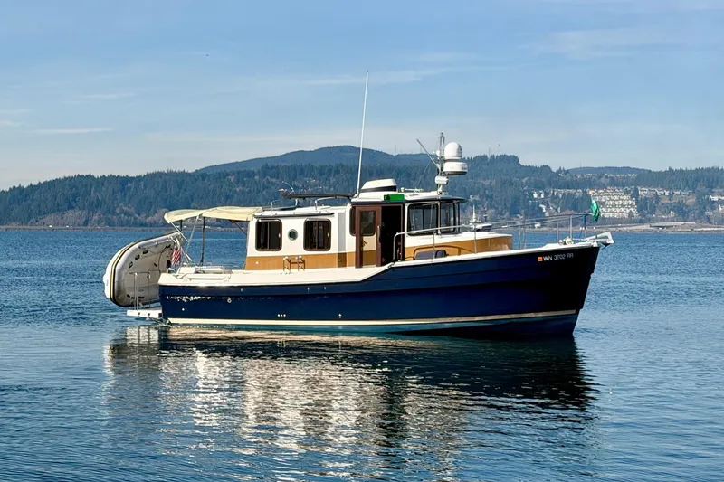 Slide: The Image of 2012 Ranger Tugs R-29 boat on calm water with scenic background. - 6