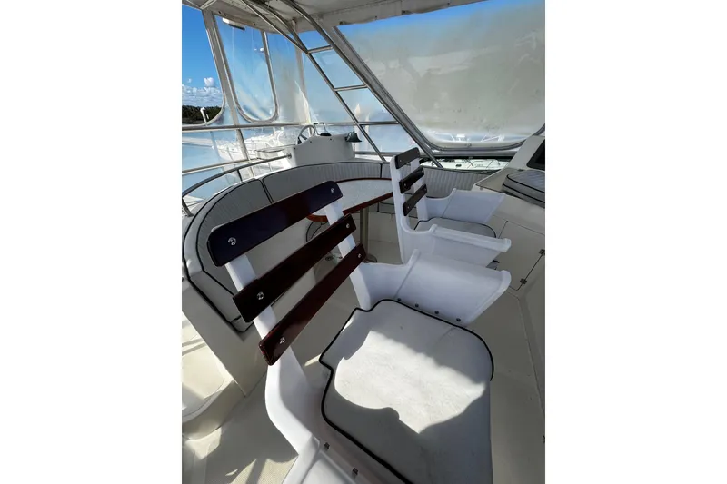 Slide: The Image of Interior of 1998 Mikelson 43 Sportfisher with white seating and wooden accents. - 10